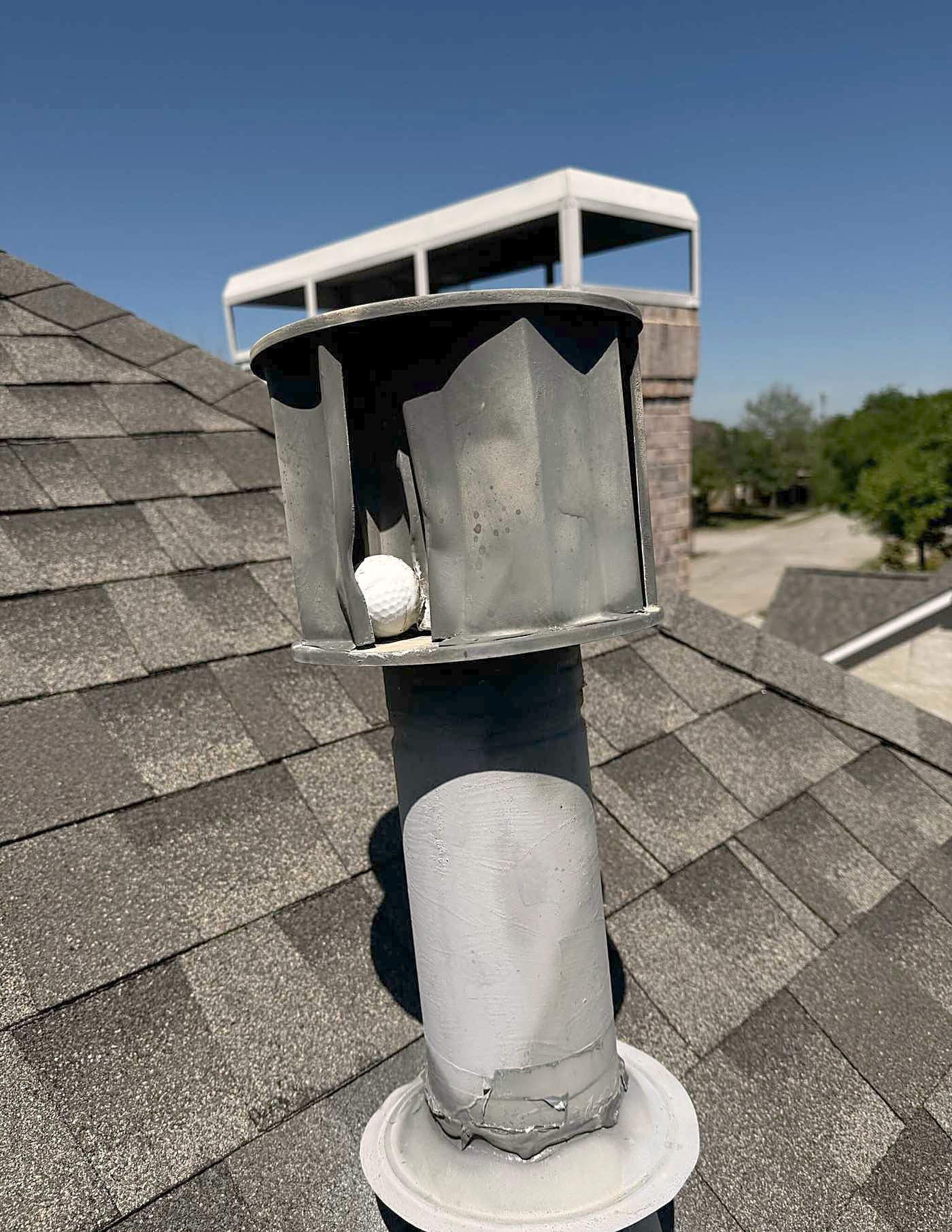 A turbine vent standing on a finished shingle roof